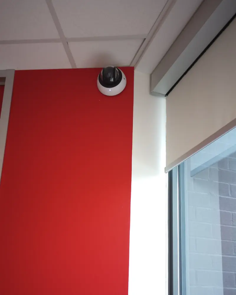 Hanwha Vision Wisenet indoor dome camera installed at the ceiling line of a commercial office corridor in Richmond Hill, ON.