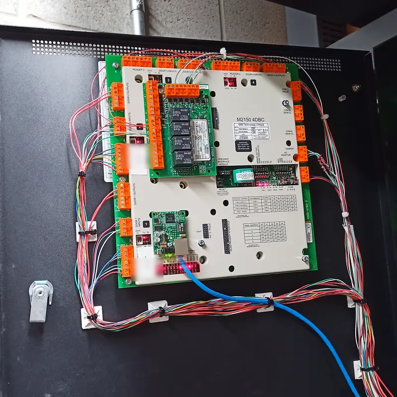 ICT Protege GX door controller in a black commercial enclosure with reader and strike wiring routed on tie mounts in Toronto, ON.