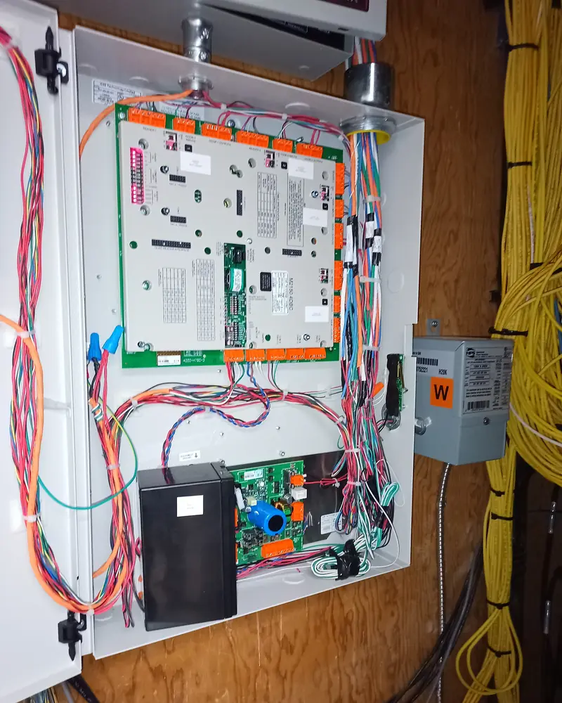 Commercial door controller in a steel enclosure with field wiring bundled and dressed for an industrial facility in Brampton, ON.