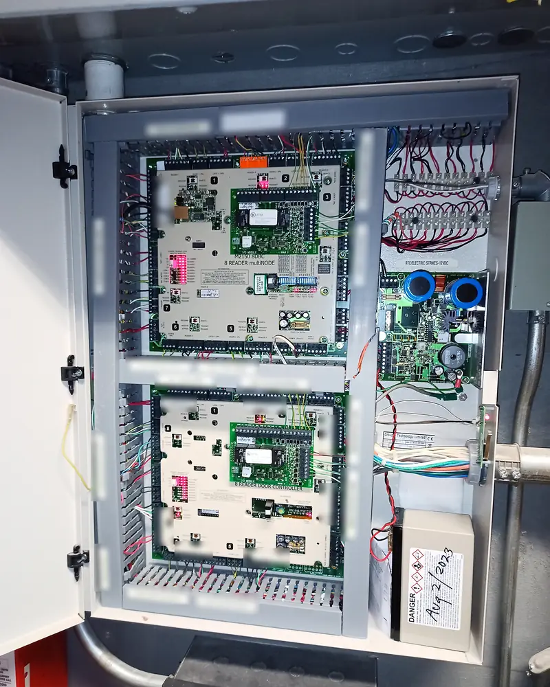 Two ICT Protege door controllers in a finger-duct enclosure with printed cable labels at every reader and lock termination for a multi-tenant office building in Mississauga, ON.