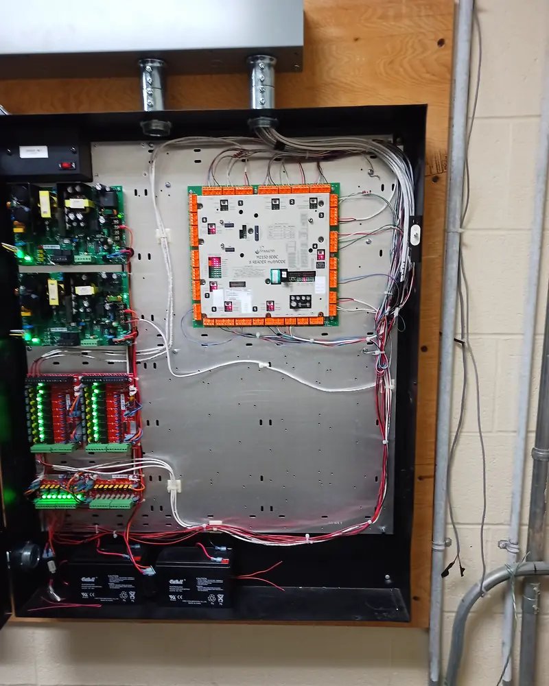 Open access control enclosure with Mercury door controller, Altronix power supplies, output boards and dual backup batteries installed for a commercial warehouse in Vaughan, ON.