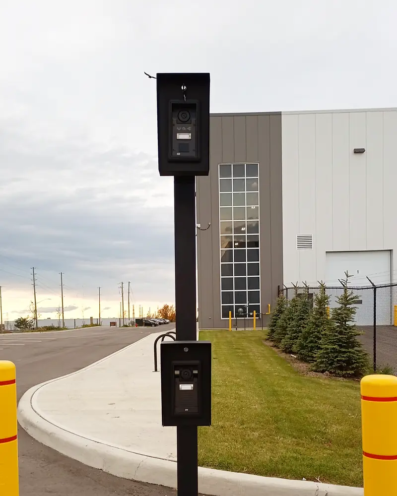 Dual-height gooseneck pedestal at a truck gate entrance with Aiphone IP video intercom stations at car and tractor-trailer height in Mississauga, ON.